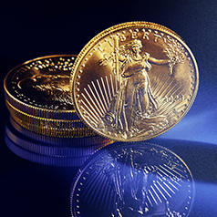 single gold liberty coin balanced against stack of gold coins on glassy blue background